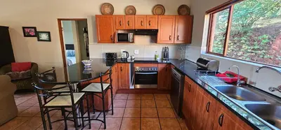 a kitchen with a sink and a counter top at Robin Cottage Da Gama Lake in White River