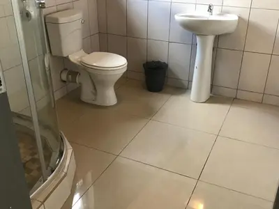 a bathroom with a toilet and a sink at Fumas guesthouse in Duvhapark