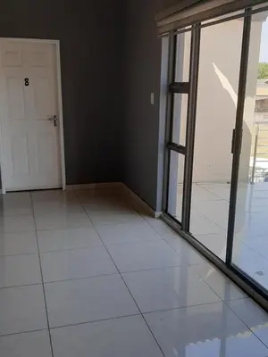 an empty room with a door and a tiled floor at Fumas guesthouse in Duvhapark