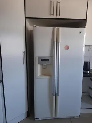 a refrigerator with a water dispenser on top of it at Fumas guesthouse in Duvhapark