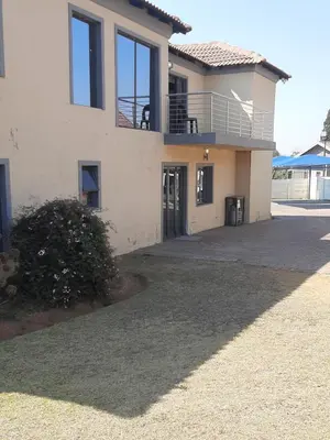 a house with a large driveway in front of it at Fumas guesthouse in Duvhapark