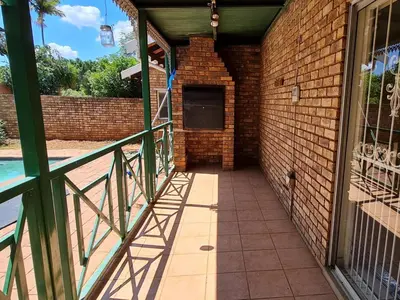 a walkway leading into a brick building at B&O's Place in Pretoria
