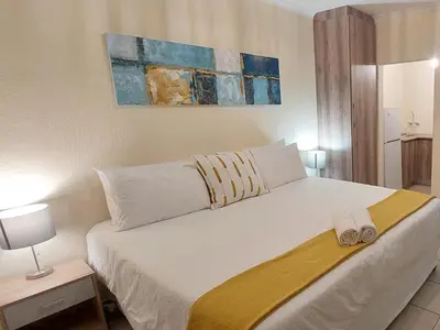 a bedroom with a bed with two towels on it at B&O's Place in Pretoria
