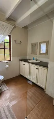 a bathroom with a sink and a glass shower at Fairstream 1 in Dullstroom
