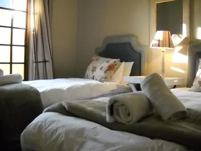 a hotel room with two beds with towels on them at Fairstream 1 in Dullstroom