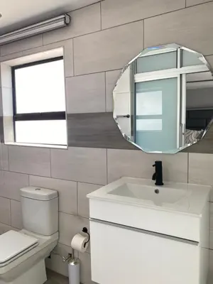 a bathroom with a white sink and a mirror at THABAKGOLO GUEST HOUSE in Ga-Manapane