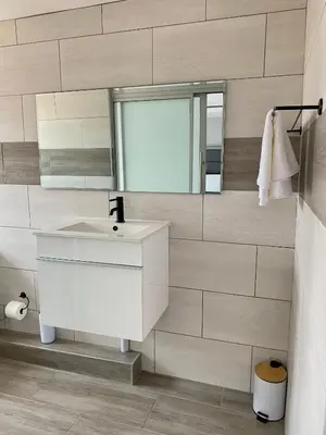 a bathroom with a white sink and a mirror at THABAKGOLO GUEST HOUSE in Ga-Manapane
