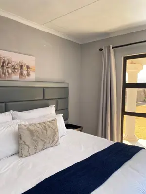 a bedroom with a white bed and a window at THABAKGOLO GUEST HOUSE in Ga-Manapane