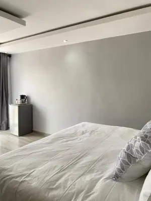 a bed in a bedroom with a white wall at THABAKGOLO GUEST HOUSE in Ga-Manapane