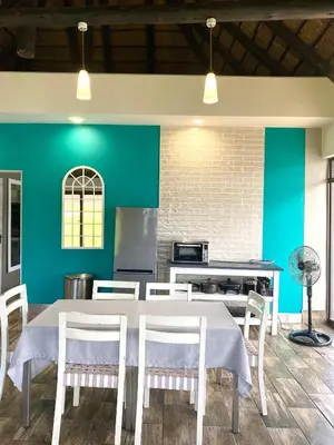 a dining room with a table and chairs at LAKE-HOUSE CABIN in Witbank