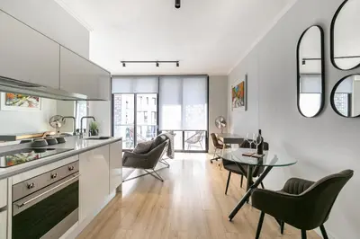 a kitchen and dining room with a table and chairs at Basia @Ellipse Waterfall in Midrand