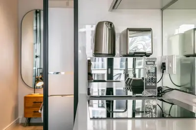 a kitchen with a glass shelf with a appliance at Basia @Ellipse Waterfall in Midrand