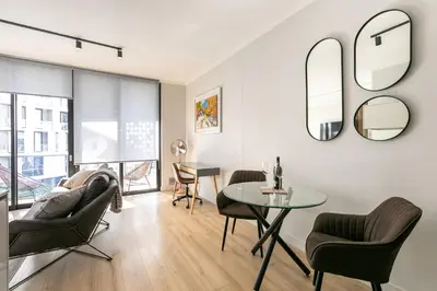 a living room with a table and chairs at Basia @Ellipse Waterfall in Midrand