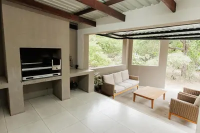 a living room with a couch and a fireplace at Chawal Stays Swartwitpens in Marloth Park