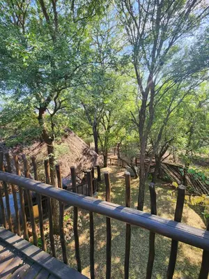 a wooden fence with trees in the background at Kudu Mal in Marloth Park