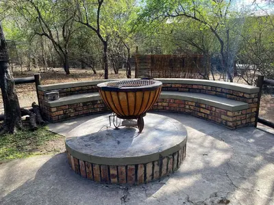 a fire hydrant sitting on a table in a park at Kudu Mal in Marloth Park
