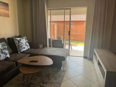 a living room with a couch and a table at Centurion: Chilled Townhouse in Centurion