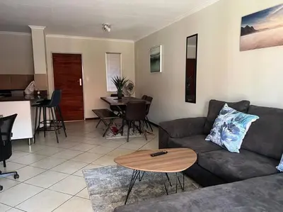a living room with a couch and a table at Centurion: Chilled Townhouse in Centurion