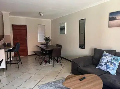 a living room with a couch and a table at Centurion: Chilled Townhouse in Centurion
