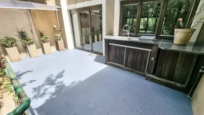 an empty patio with a sink and a counter at Montrose River Lodge in Schoemanskloof