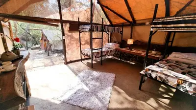 a room with two bunk beds in a tent at Montrose River Lodge in Schoemanskloof
