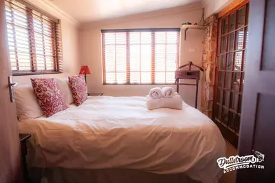 a bedroom with a bed with two towels on it at Duckling Cottage in Dullstroom