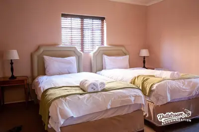 two beds sitting next to each other in a bedroom at Duckling Cottage in Dullstroom