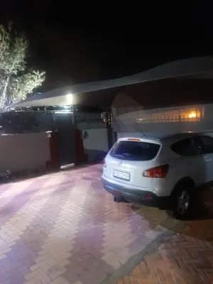 a white car parked in a parking lot at night at Cozy guesthouse-springs in Springs