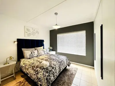 a bedroom with a bed and a window at 15min to OR TAMBO perfect long stay WiFi & Netflix in Benoni