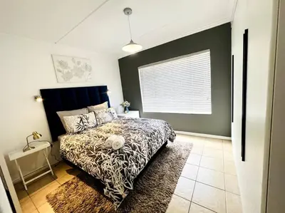 a bedroom with a bed and a window in it at 15min to OR TAMBO perfect long stay WiFi & Netflix in Benoni
