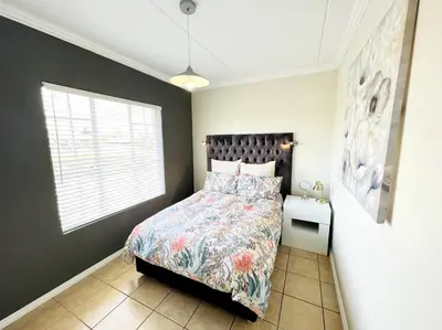 a bedroom with a bed and a window in it at 15min to OR TAMBO perfect long stay WiFi & Netflix in Benoni