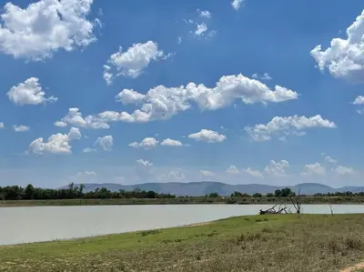 a large body of water with clouds in the sky at Lodge on Watering Hole , Zebula in Mabula