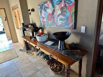 a table in a room with a painting on the wall at Luna Crescente 19 and 19A Zebula golf and spa resort 14 Pax Bela Bela Limpopo in Mabula