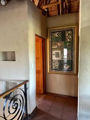a hallway with a door and a stained glass window at Luna Crescente 19 and 19A Zebula golf and spa resort 14 Pax Bela Bela Limpopo in Mabula