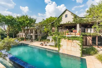 an exterior view of a house with a swimming pool at Luxurious Hideaway Villa in Midrand