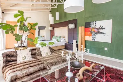 a living room with a couch and a bed at Luxurious Hideaway Villa in Midrand