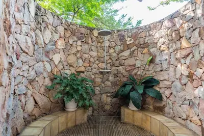 a stone wall with two potted plants on it at Luxurious Hideaway Villa in Midrand
