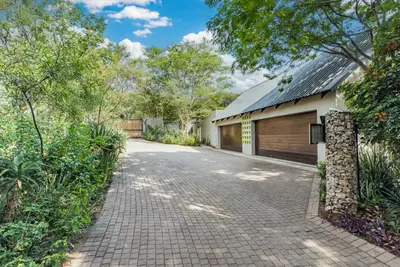 a driveway in front of a house with a garage at Luxurious Hideaway Villa in Midrand