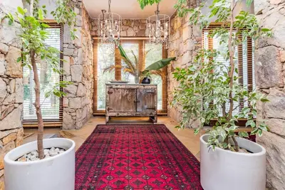 a hallway with two potted plants and a red rug at Luxurious Hideaway Villa in Midrand