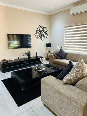 a living room with a couch and a coffee table at Ultimate Sky-2 bedroom villa in Pretoria