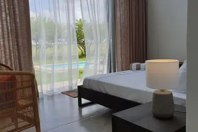 a bedroom with a bed and a large window at Lindi Lodge, Mjejane Game Reserve in Hectorspruit