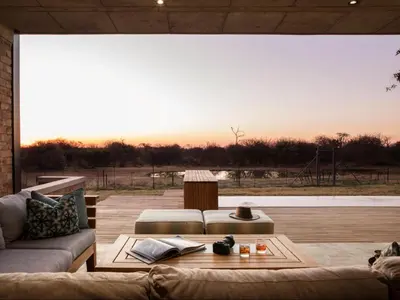 a living room with a couch and a table at NAKO Safari Lodge in Dinokeng Game Reserve