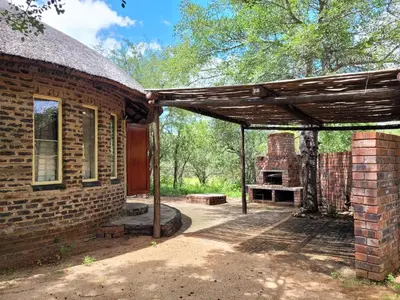 an outside view of a brick building with a patio at Hardekool Home Marloth Park in Marloth Park
