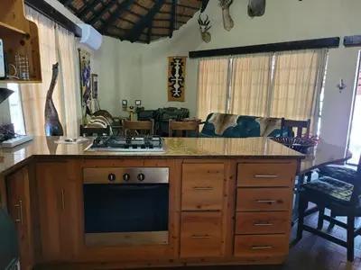 a kitchen with a stove and a counter top at Hardekool Home Marloth Park in Marloth Park