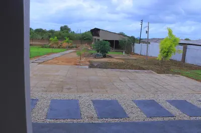 a courtyard with blue tiles on the ground at Lis ville guest house in Phalaborwa
