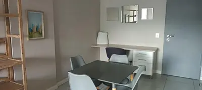 a dining room with a table and chairs at Menlyn Maine Trilogy Apartment 1010 in Pretoria