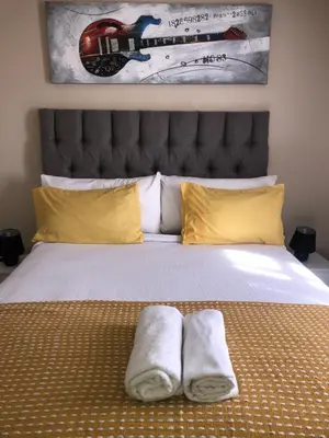 a bedroom with a bed with two towels on it at Menlyn Bizcation Accommodation in Pretoria