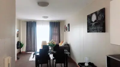 a living room with a table and chairs and a window at Menlyn Bizcation Accommodation in Pretoria