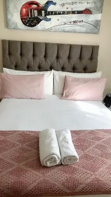 a bed with two towels sitting on top of it at Menlyn Bizcation Accommodation in Pretoria