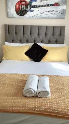 a bedroom with a bed with two towels on it at Menlyn Bizcation Accommodation in Pretoria
